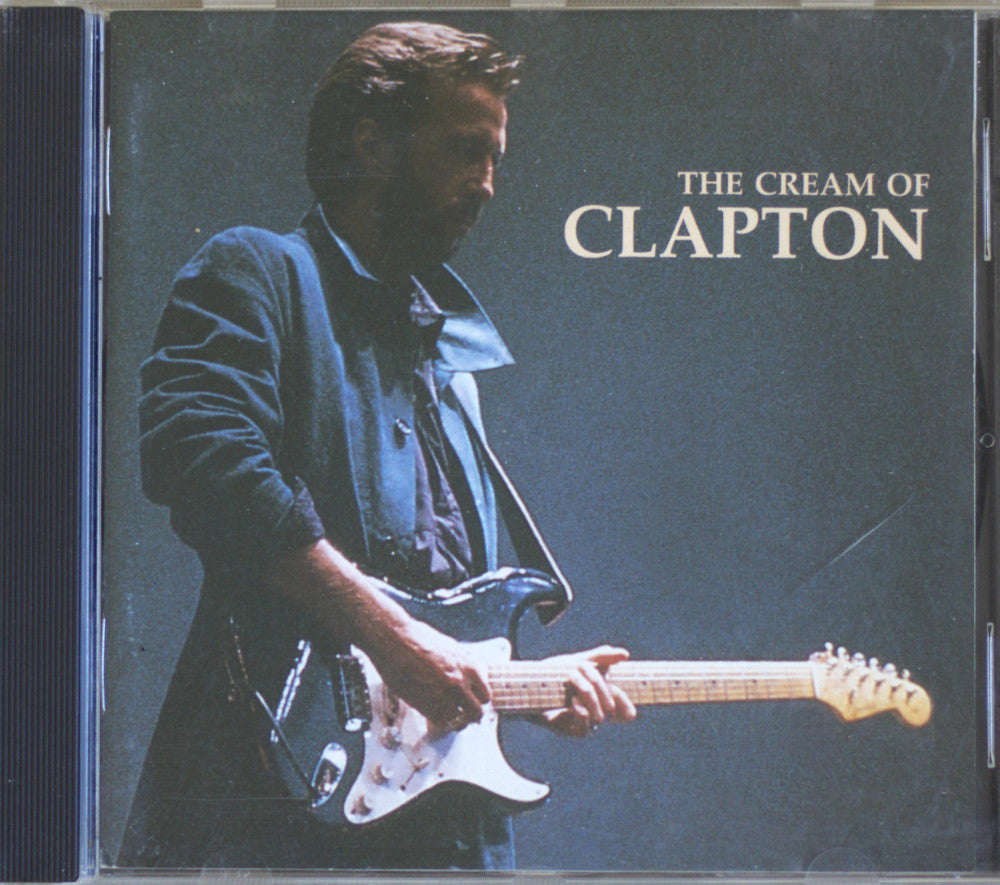 CD cover for 'The Cream of Clapton' featuring a photo of Eric Clapton playing an electric guitar against a dark blue background, with the title in white text.