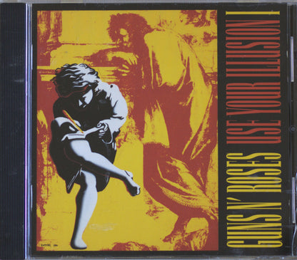 Guns N' Roses 'Use Your Illusion' CD album cover, featuring a bold yellow and red graphic design with black and white illustrated figures and vertical text on the right side.