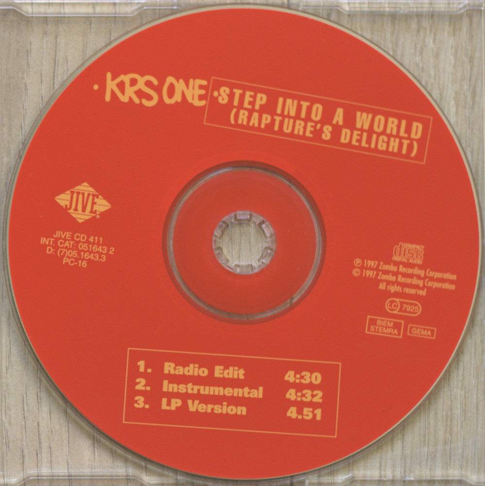 A red CD disc for KRS One's 'Step Into A World (Rapture's Delight)' on IVE, photographed inside a clear plastic jewel case on a light wood surface.
