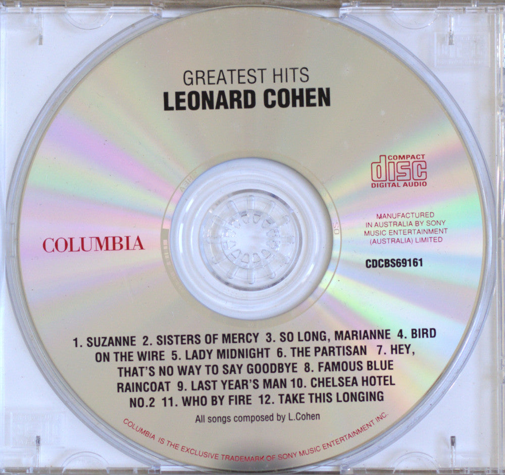 Leonard Cohen 'Greatest Hits' CD single cover from Columbia/Sony, showing the compact disc inside a clear jewel case with tracklist text printed on the disc.