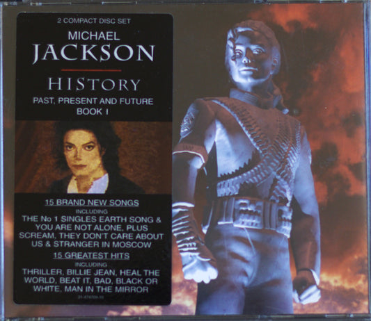 Michael Jackson 'History: Past, Present and Future Book 1' 2-compact disc set in a jewel case, featuring a black cover with white text and a blue-toned portrait of Michael Jackson on the right against a fiery red background.
