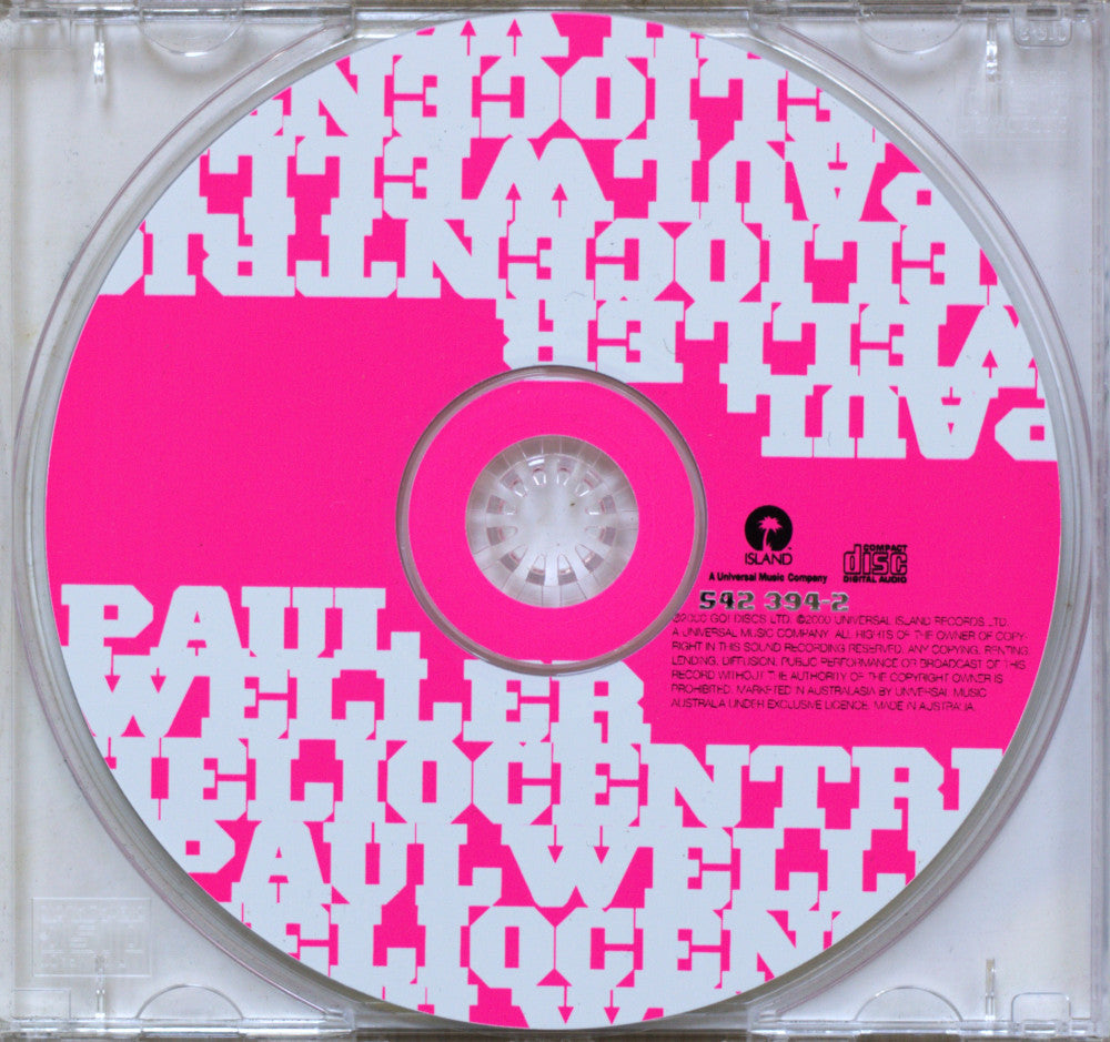 A CD disc with a bright pink and white graphic design featuring the text PAUL Weller, housed in a clear plastic jewel case.