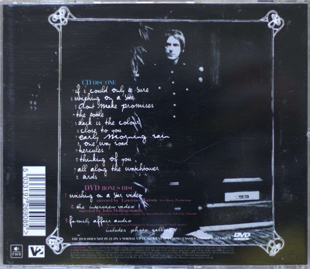 The back cover of a CD case for Paul Weller Studio 150 album, featuring a dark, grainy photo of a person in a dark room with handwritten tracklist text and a barcode.