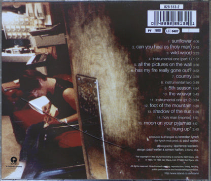 The back cover of a CD album for 'Wild Wood' by Paul Weller, showing track listings, a barcode, and the cover artwork on a dark brown background.