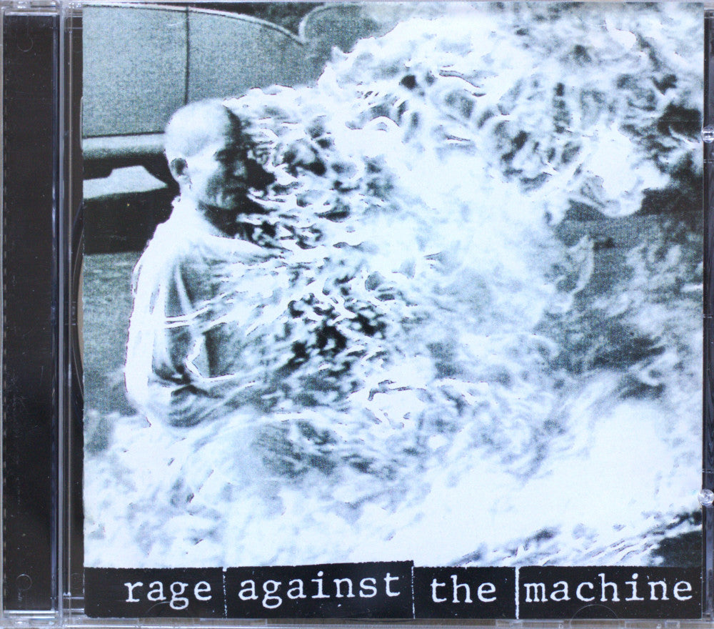 CD cover for the band 'Rage Against the Machine', featuring a grainy black-and-white photo of a person partially obscured by a chaotic, flame-like white overlay, with the band name printed in white text on a black bar at the bottom.