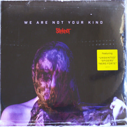 Slipknot 'We Are Not Your Kind' vinyl record cover, sealed in plastic shrink wrap. The cover art features a dark, moody portrait of a person wrapped in a bloody bandage, with the band's name in red and the yellow 'Featuring' sticker on the right.