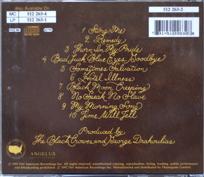 The back cover of a cd for The Black Crowes, featuring a dark brown background with gold text listing the 10 track titles and credits, alongside barcode and catalog information.