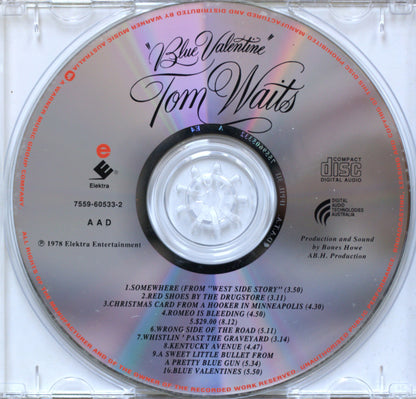 A vintage compact disc single for Tom Waits' album 'Blue Valentine', featuring a silver reflective disc with black text and tracklist details, photographed inside its clear plastic jewel case.